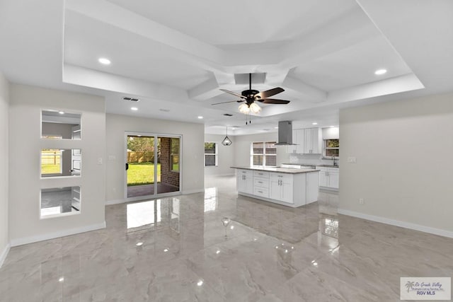 kitchen with a kitchen island, island range hood, sink, white cabinets, and coffered ceiling