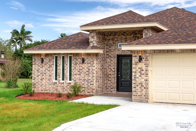 view of front of property featuring a garage and a front lawn