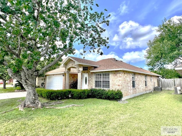 2602 E Mark Cir, Harlingen, TX 78550 - ranch-style house featuring an attached garage, stone siding, and roof with shingles