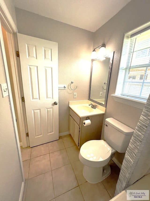 2602 E Mark Cir, Harlingen, TX 78550 - bathroom featuring toilet, tile patterned floors, vanity, and baseboards