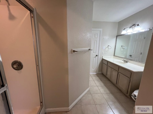 2602 E Mark Cir, Harlingen, TX 78550 - full bathroom with vanity, tile patterned floors, baseboards, and a shower with shower door