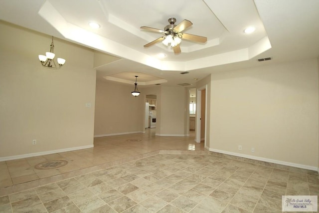 2602 E Mark Cir, Harlingen, TX 78550 - empty room featuring a raised ceiling, ceiling fan, recessed lighting, a chandelier, and baseboards