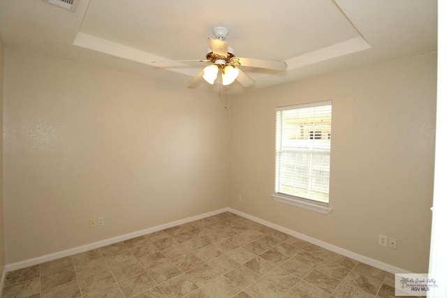 2602 E Mark Cir, Harlingen, TX 78550 - unfurnished room featuring a raised ceiling, baseboards, and a ceiling fan