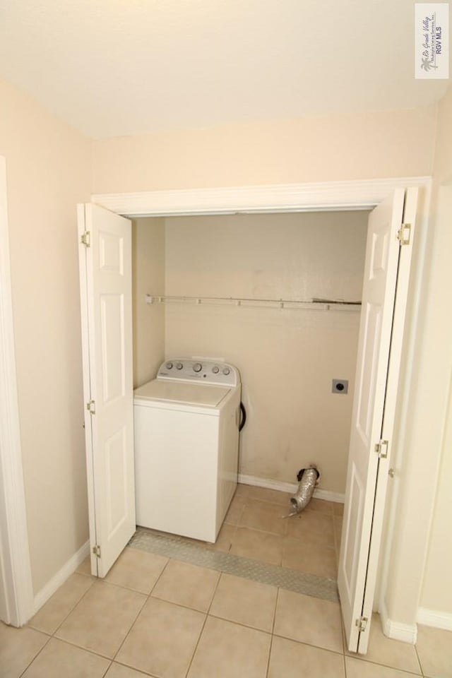 2602 E Mark Cir, Harlingen, TX 78550 - washroom featuring washer / clothes dryer, light tile patterned floors, and baseboards