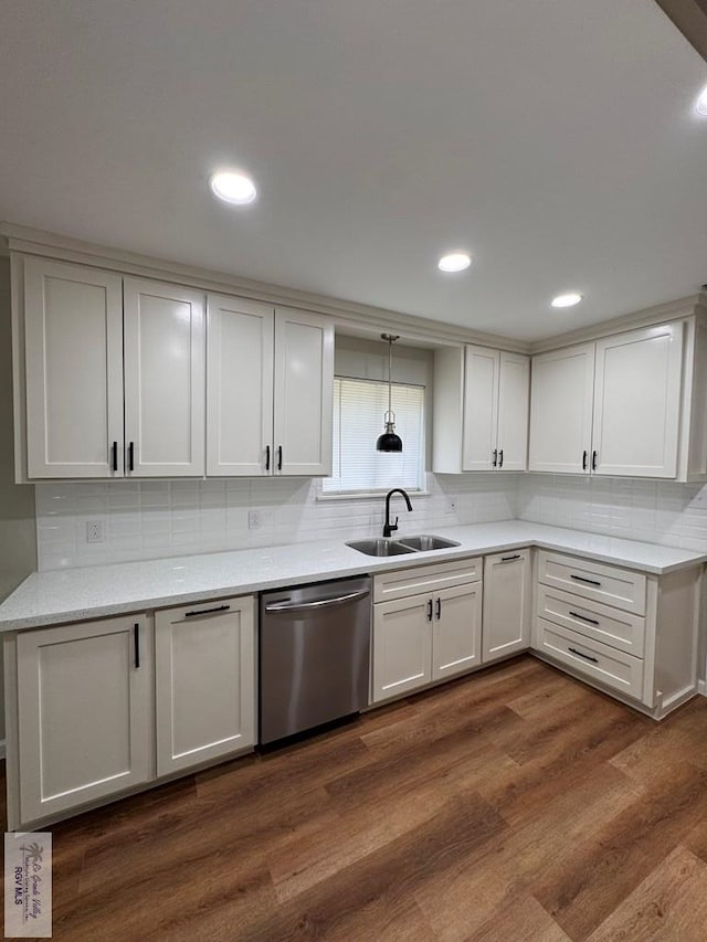 kitchen featuring white cabinetry, stainless steel dishwasher, dark wood-type flooring, and sink