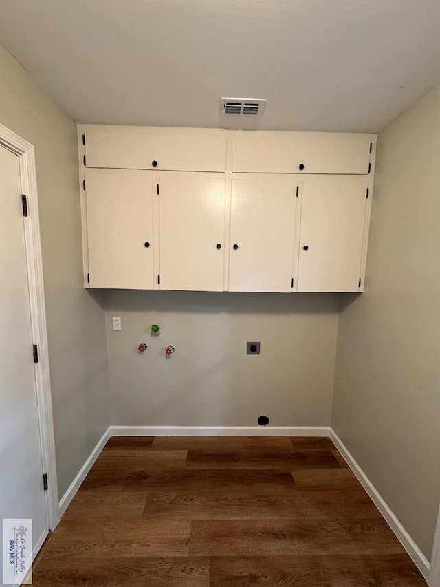 clothes washing area featuring washer hookup, dark hardwood / wood-style flooring, cabinets, and hookup for an electric dryer