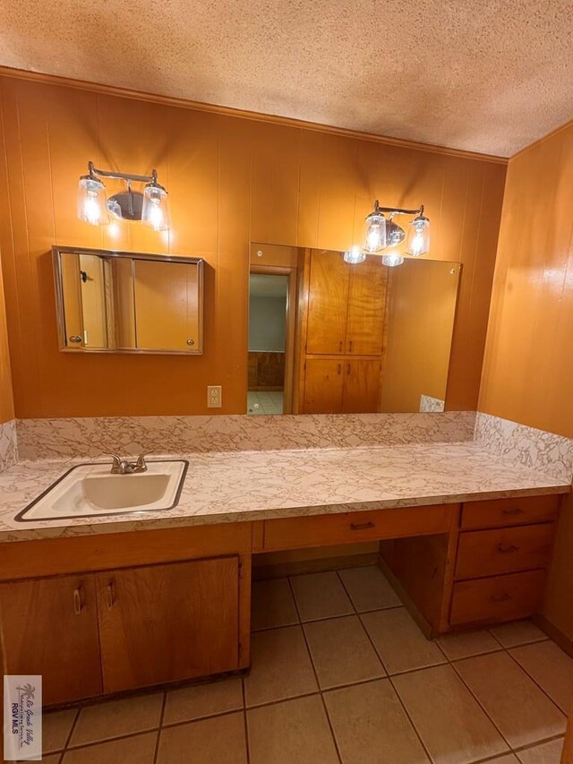 bathroom featuring tile patterned flooring, vanity, and a textured ceiling