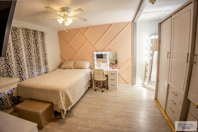 bedroom with ceiling fan and light hardwood / wood-style flooring