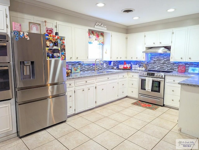 kitchen with light stone countertops, crown molding, extractor fan, white cabinets, and appliances with stainless steel finishes