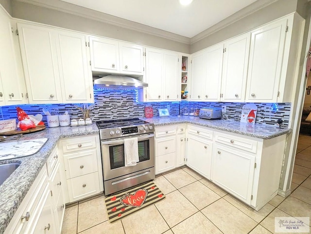 kitchen featuring stainless steel range, light tile patterned floors, and white cabinets