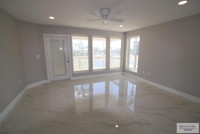 200 Padre Blvd Unit 2306, Port Isabel, TX 78597 - unfurnished room featuring healthy amount of natural light, light marble finish flooring, a ceiling fan, and recessed lighting