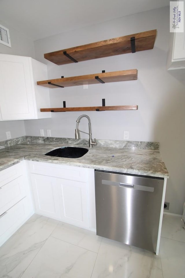 200 Padre Blvd Unit 2306, Port Isabel, TX 78597 - kitchen featuring open shelves, dishwasher, light marble finish flooring, white cabinets, and light stone counters