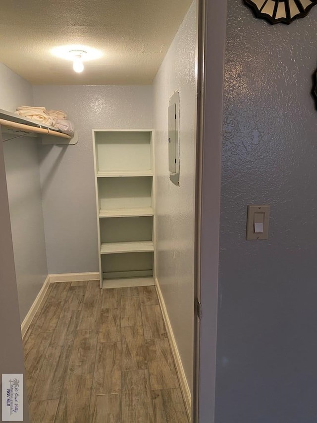 2010 El Dorado Ave, Rancho Viejo, TX 78575 - walk in closet with wood finished floors and electric panel