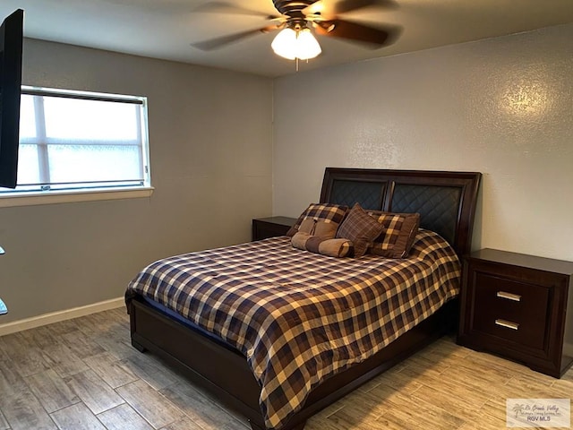 2010 El Dorado Ave, Rancho Viejo, TX 78575 - bedroom featuring light wood finished floors, ceiling fan, and baseboards