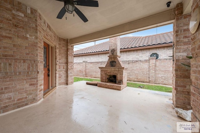 view of patio featuring an outdoor brick fireplace and ceiling fan