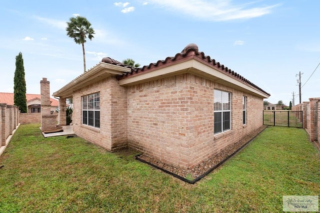 view of side of home with a yard