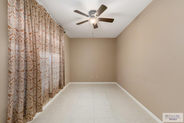 empty room with light tile patterned flooring and ceiling fan