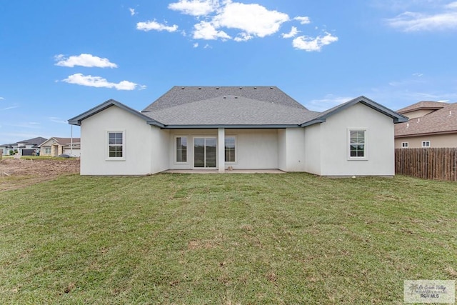 rear view of house featuring a yard