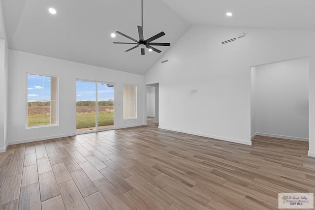 empty room with high vaulted ceiling and ceiling fan