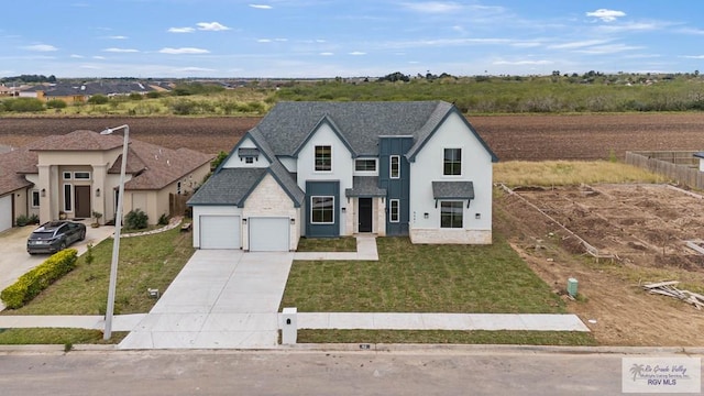 view of front facade with a garage and a front lawn