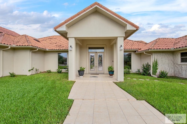 doorway to property with a lawn