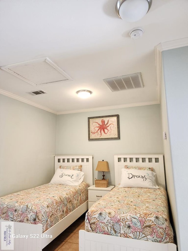 bedroom featuring ornamental molding and light tile patterned floors