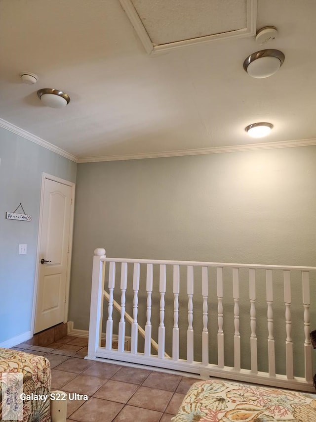 hall with crown molding and light tile patterned floors