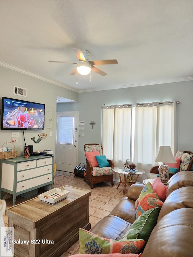 tiled living room featuring crown molding and ceiling fan