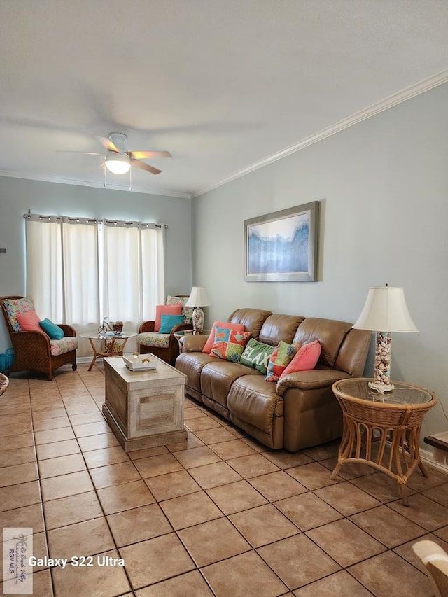 living room featuring ceiling fan, ornamental molding, and light tile patterned flooring