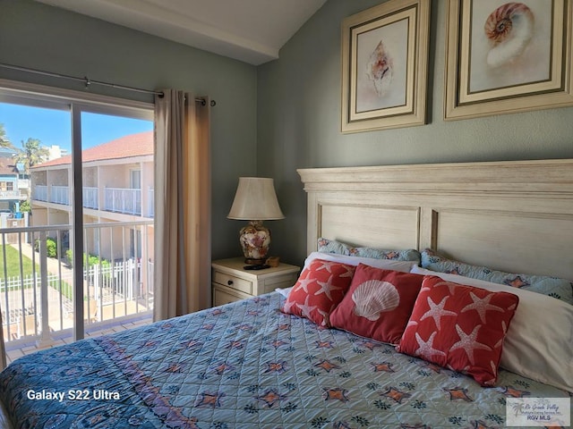 bedroom with access to exterior and lofted ceiling