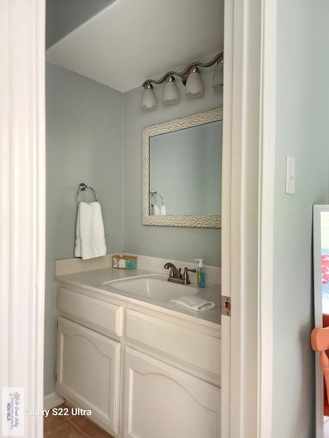 bathroom featuring tile patterned flooring and vanity