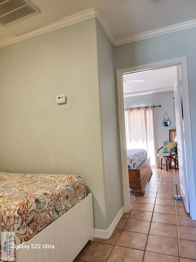 tiled bedroom featuring crown molding