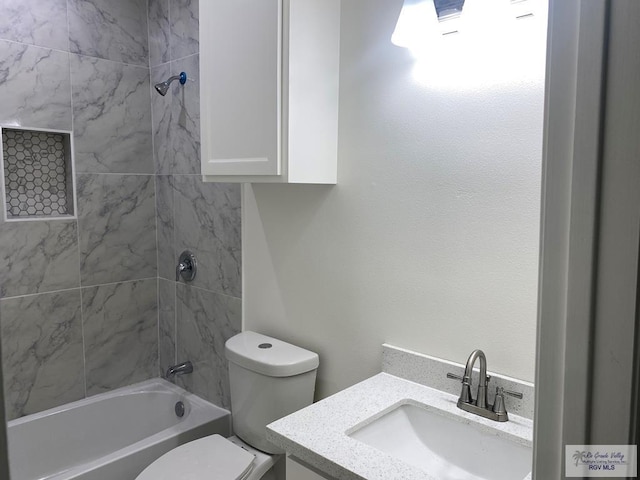 full bathroom featuring vanity, toilet, and tiled shower / bath