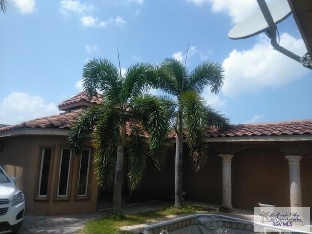 view of home's exterior with a tiled roof