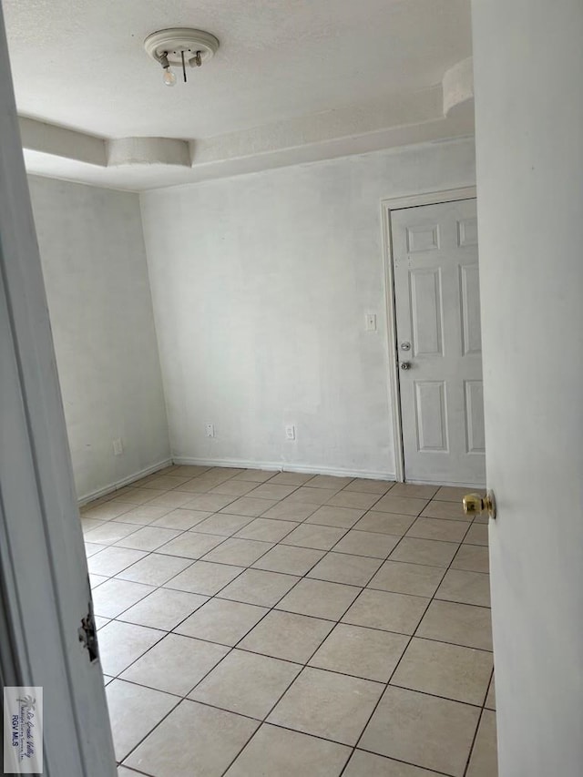 empty room with light tile patterned floors