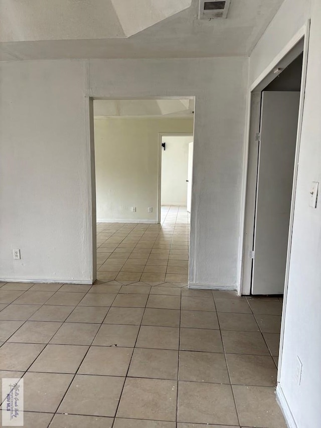 unfurnished room with light tile patterned floors