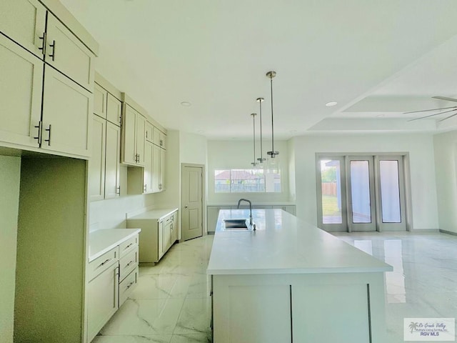 534 Billy Mitchell Blvd, Brownsville, TX 78520 - kitchen featuring a center island with sink, light marble finish floors, hanging light fixtures, recessed lighting, and light countertops