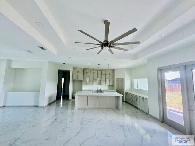534 Billy Mitchell Blvd, Brownsville, TX 78520 - kitchen with a raised ceiling, recessed lighting, ceiling fan, gray cabinets, and a kitchen island