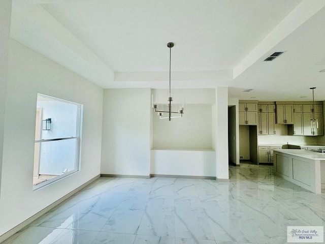 534 Billy Mitchell Blvd, Brownsville, TX 78520 - unfurnished dining area featuring light marble finish floors, a chandelier, and a tray ceiling