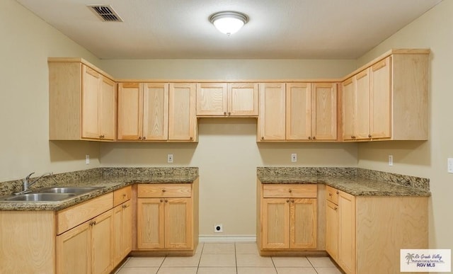 kitchen featuring sink and light brown cabinetry