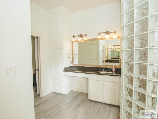 100 Paloma St, San Benito, TX 78586 - bathroom with wood finished floors and vanity