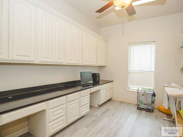 100 Paloma St, San Benito, TX 78586 - unfurnished office with light wood finished floors, built in desk, baseboards, and ceiling fan