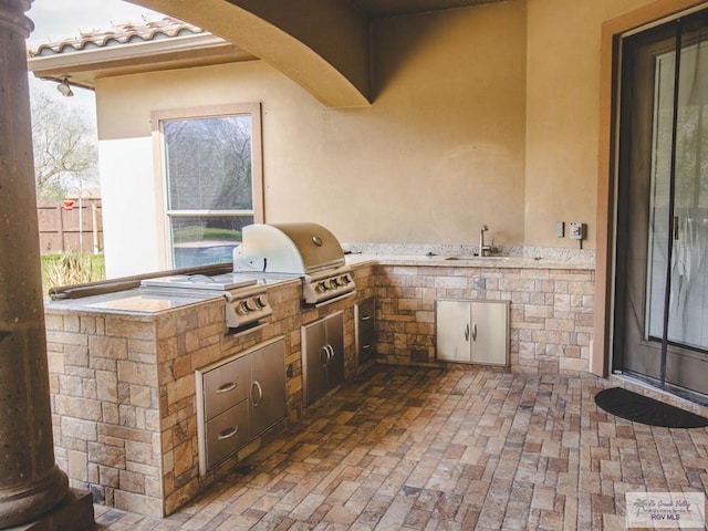 100 Paloma St, San Benito, TX 78586 - view of patio / terrace with area for grilling, fence, and a sink