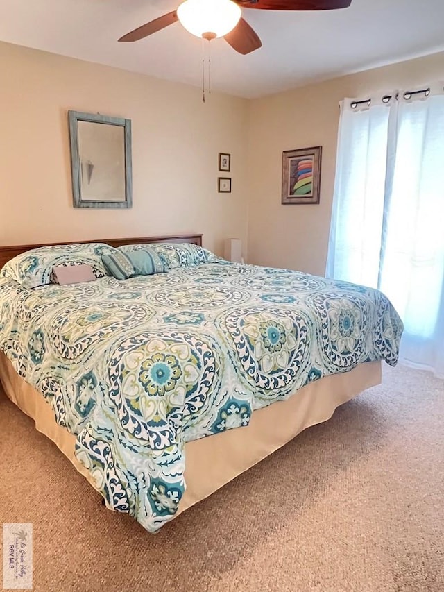 bedroom featuring a ceiling fan and carpet