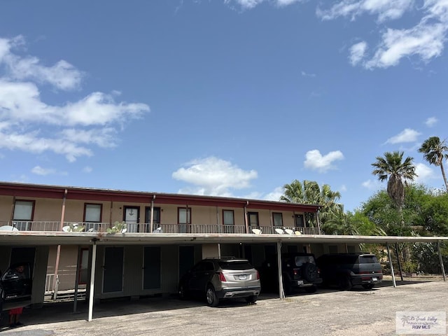 view of front of property with covered parking and stucco siding