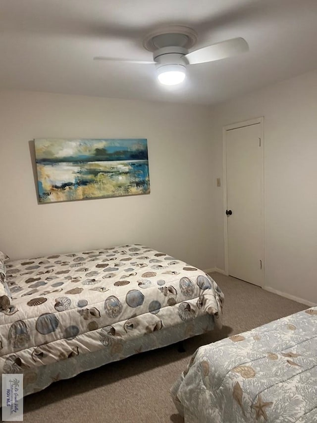 carpeted bedroom featuring baseboards and ceiling fan