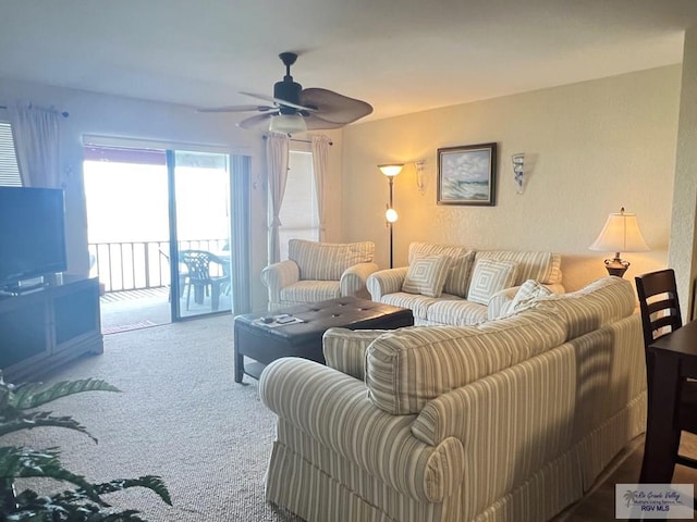 living area featuring ceiling fan and carpet