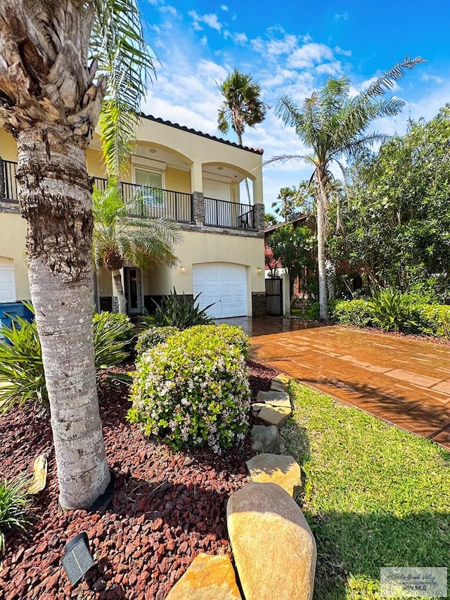 107 E Palm St Unit B, South Padre Island, TX 78597 - view of yard with a balcony and an attached garage