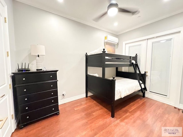 107 E Palm St Unit B, South Padre Island, TX 78597 - bedroom with baseboards, ornamental molding, light wood finished floors, and a wall mounted AC