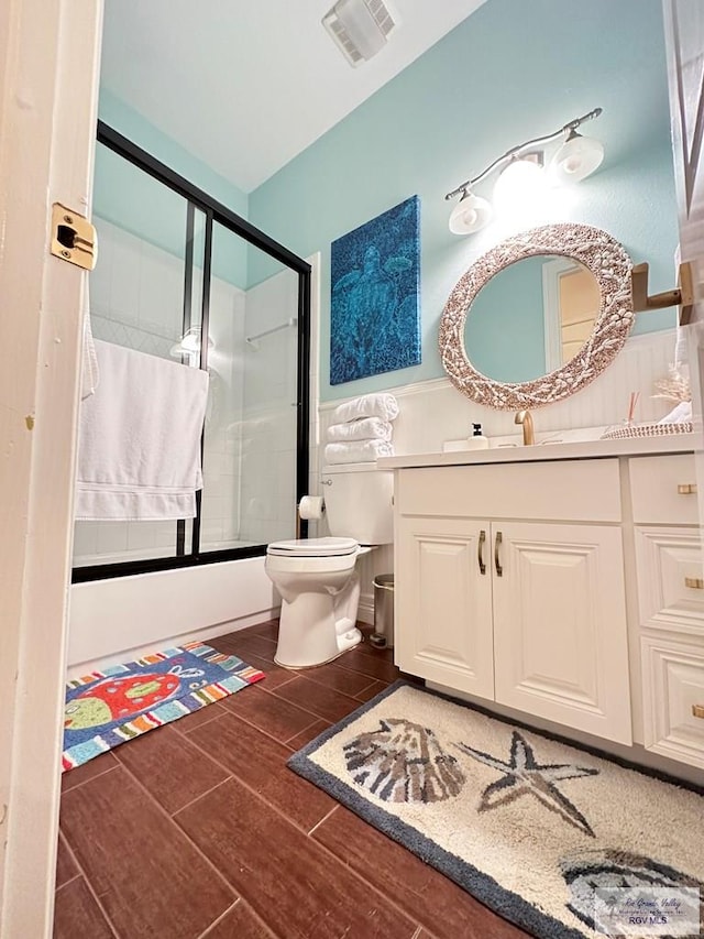 107 E Palm St Unit B, South Padre Island, TX 78597 - full bathroom featuring visible vents, wood finished floors, an enclosed shower, and toilet